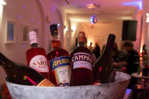 Eiskübel mit Flaschen von Sarti Rosa, Aperol, Campari und Wein.